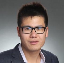 A person wearing glasses and a blazer.