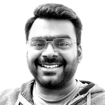 A person smiling wearing glasses.