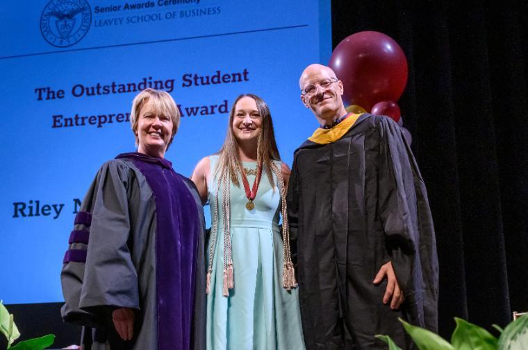 Three smiling people at the LSB Awards ceremony, text in the background.