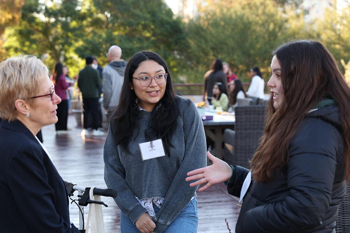 Three people networking and laughing at the Ciocca Center Presidents Breakfast event.