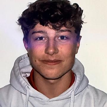 Man smiling in white hoodie