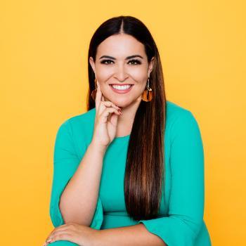 A person in a green top against a yellow background.