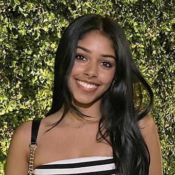 Woman in striped top smiling outdoors