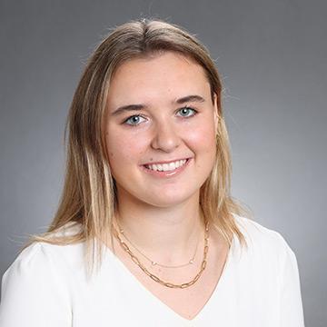 Woman in white top smiling