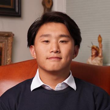 man smiling in suit and tie outdoors 