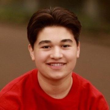 Man in red tshirt outdoors smiling