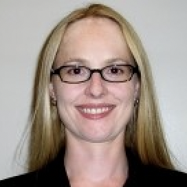 A person wearing glasses and smiling.