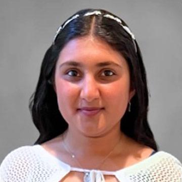 Woman with white headband and top smiling