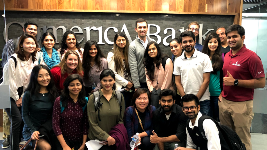 Students attend company trek at Comerica and pose for a group photo.