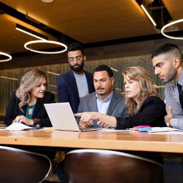 Leavey School of Business MBA students discussing over a laptop