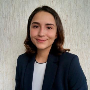 A person smiling in a professional headshot.