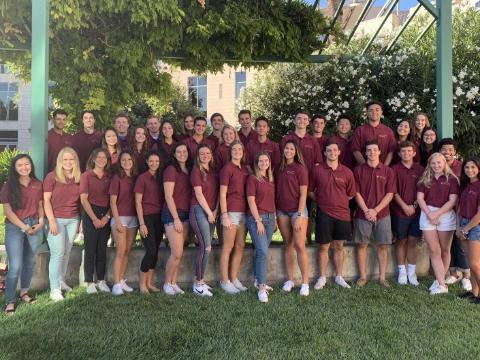 Group of peer advisors in matching shirts posing outdoors, 2019-2020. image link to story