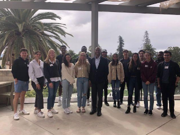 Alt text: Group photo titled 'Presidents Council Fall 2021' with people standing outdoors.