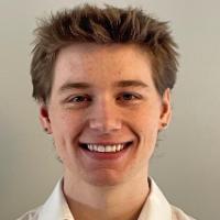 A person smiling in a white shirt.