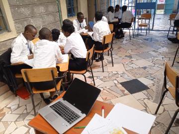 Photo Twajali Scene of Students at Desks