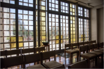 Image of rows of chairs within a religious facility