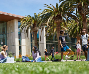 Photo of SCU SCDI building and students sitting on grass