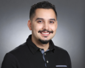 A person smiling in a professional headshot.