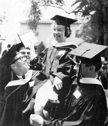 Four graduates in caps and gowns holding diplomas, smiling, titled 'Mary Somers Edmunds Historic Picture'.