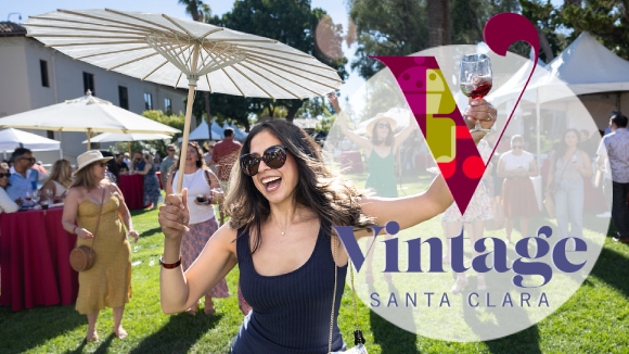 A smiling woman holding a parasol and a wine glass. Overlaid text reads 