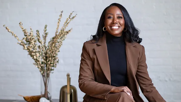 A smiling woman in professional wear.