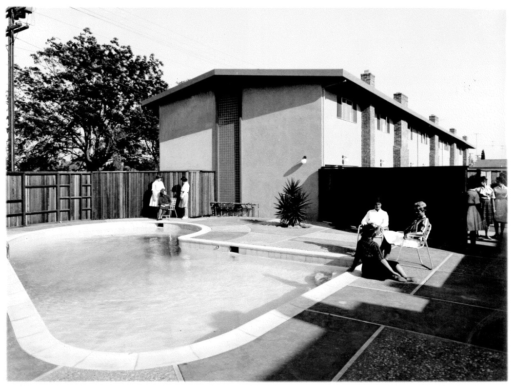 Alt text: Women sitting by the pool at off-campus residence.