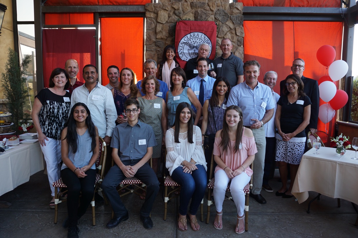 A group of people posing together in front of a restaurant.