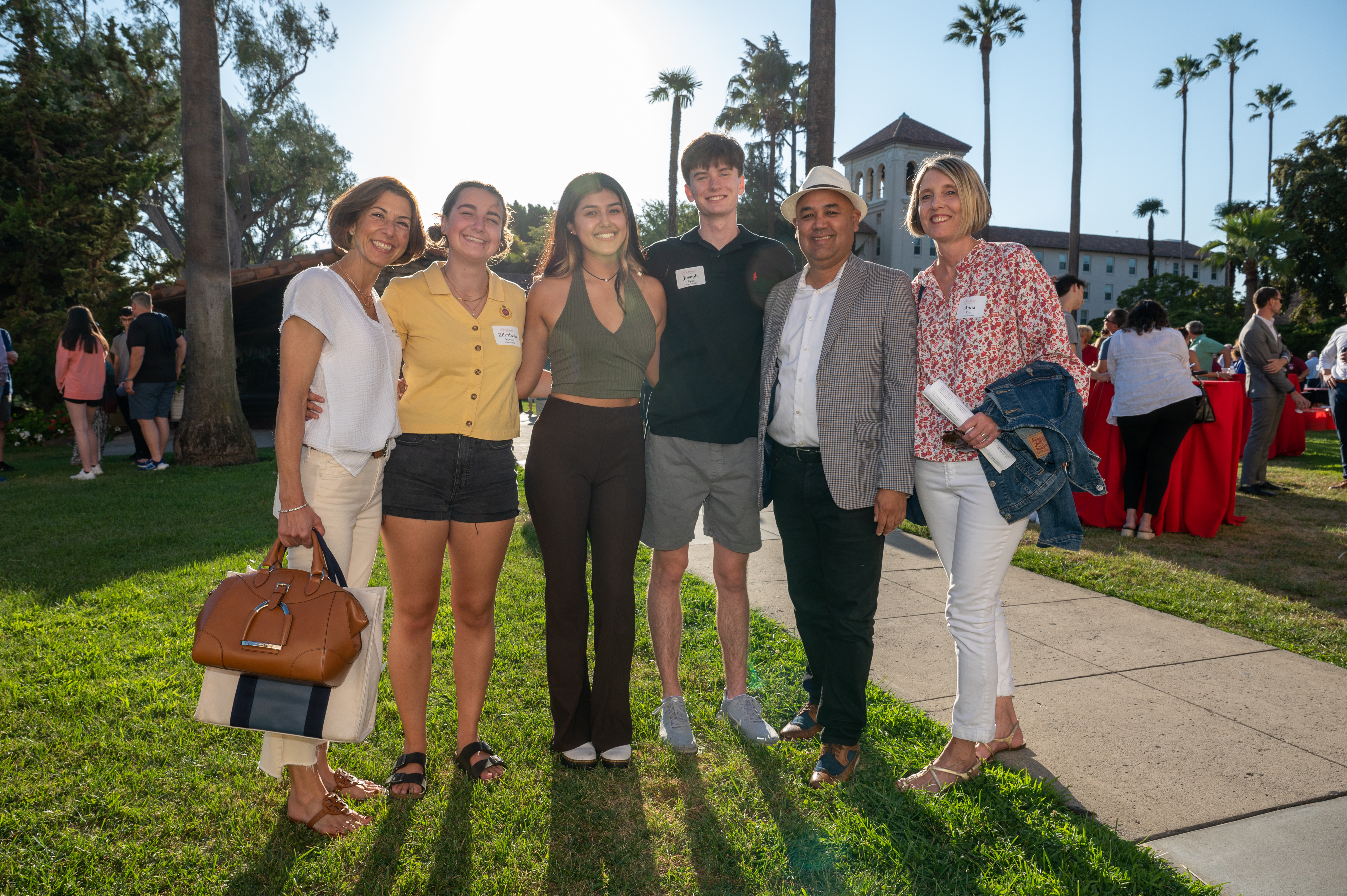 A group of people posing outdoors at Legacy BBQ event.