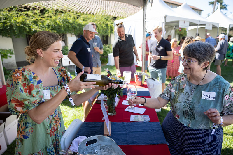 Vintage 2024 Wine being poured into a cup between two women