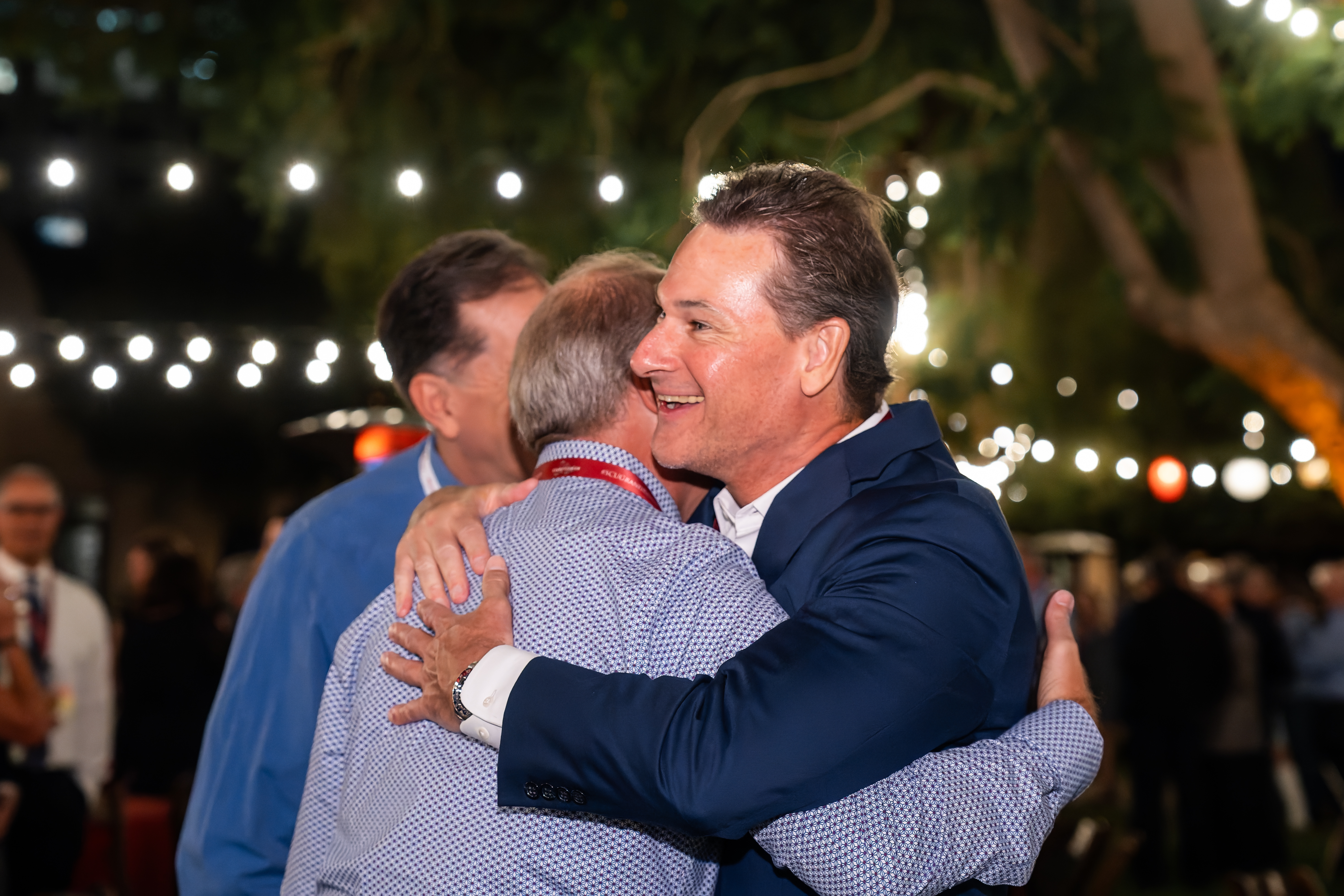 Two men smiling and hugging at Santa Clara University's Grand Reunion 
