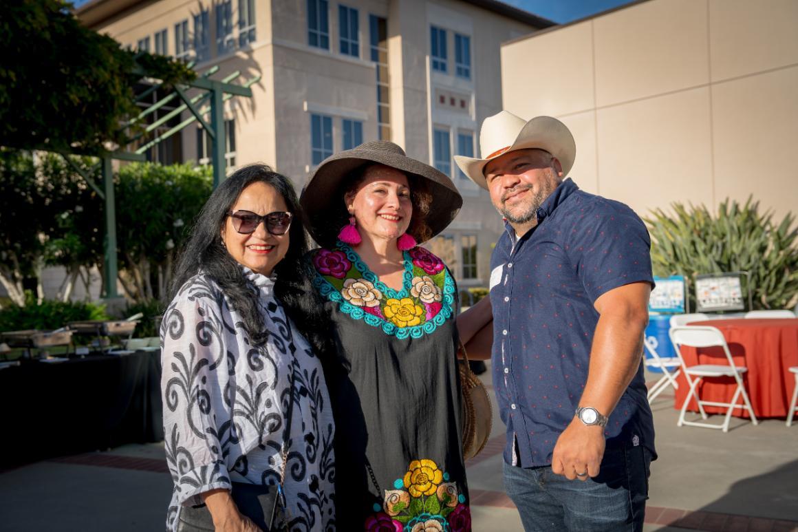 Two women and one man of Latinx ancestry smiling for the camera at Santa Clara University's Latinx Alumni Social at Grand Reunion.