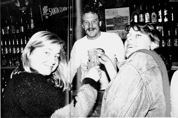 Three people smiling and laughing in '1984 Hut.'