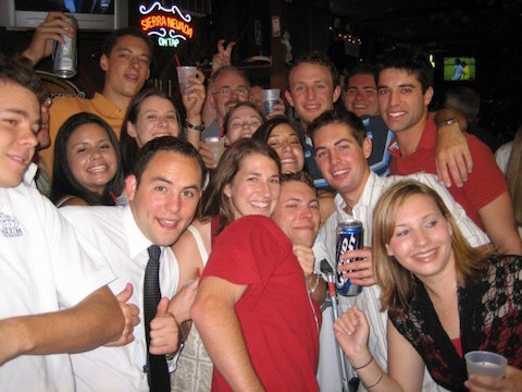 A group of people at a social gathering, smiling for a photo.