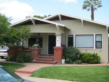 A bungalow-style house with a lawn and front porch.