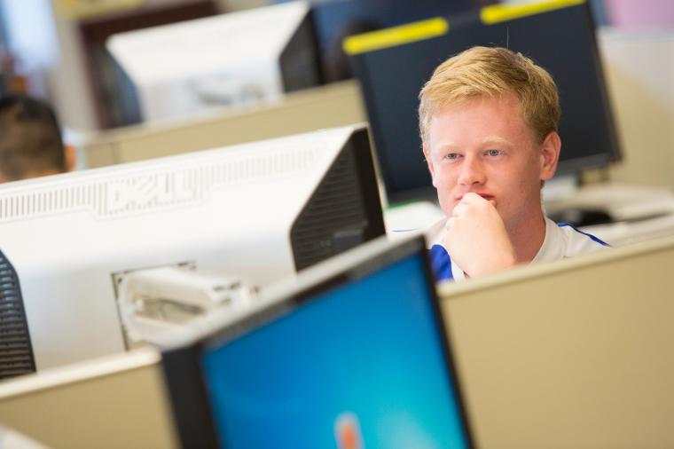 A person working at a computer in an office.
