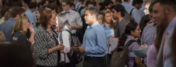 People gather in a crowded space, engaging and interacting.