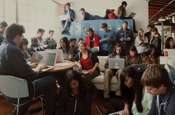 A diverse group of people working in an open and collaborative workspace.