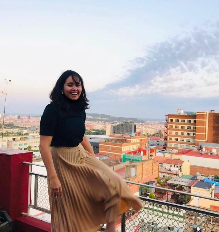 Jacqui next to a railing overlooking the city