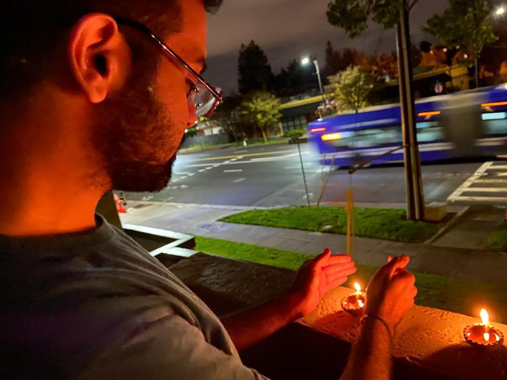 Photo of man lighting a candle
