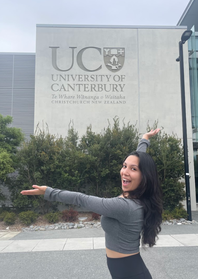 Decorative; student posing in front of a university building