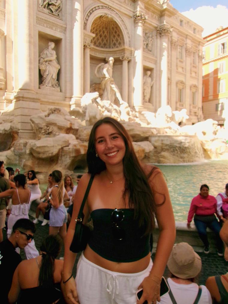Decorative; student posing in front of a fountain