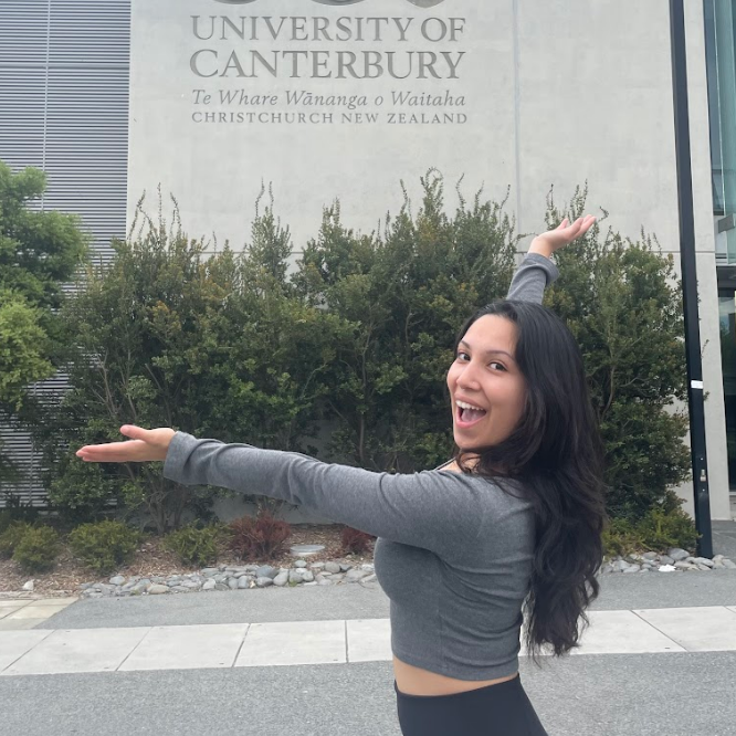 Decorative; student posing in front of a campus building