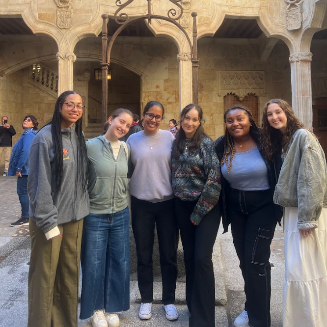 Decorative; group of students posing in front of an old building
