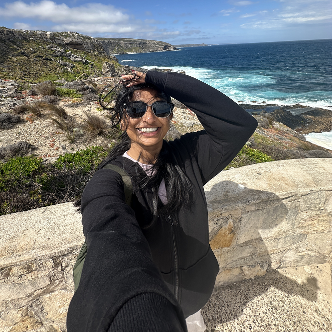 Decorative; student taking a selfie overlooking a coastline