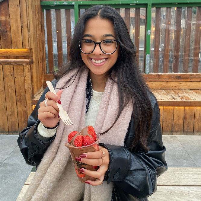 Decorative; student smiling and holding a snack
