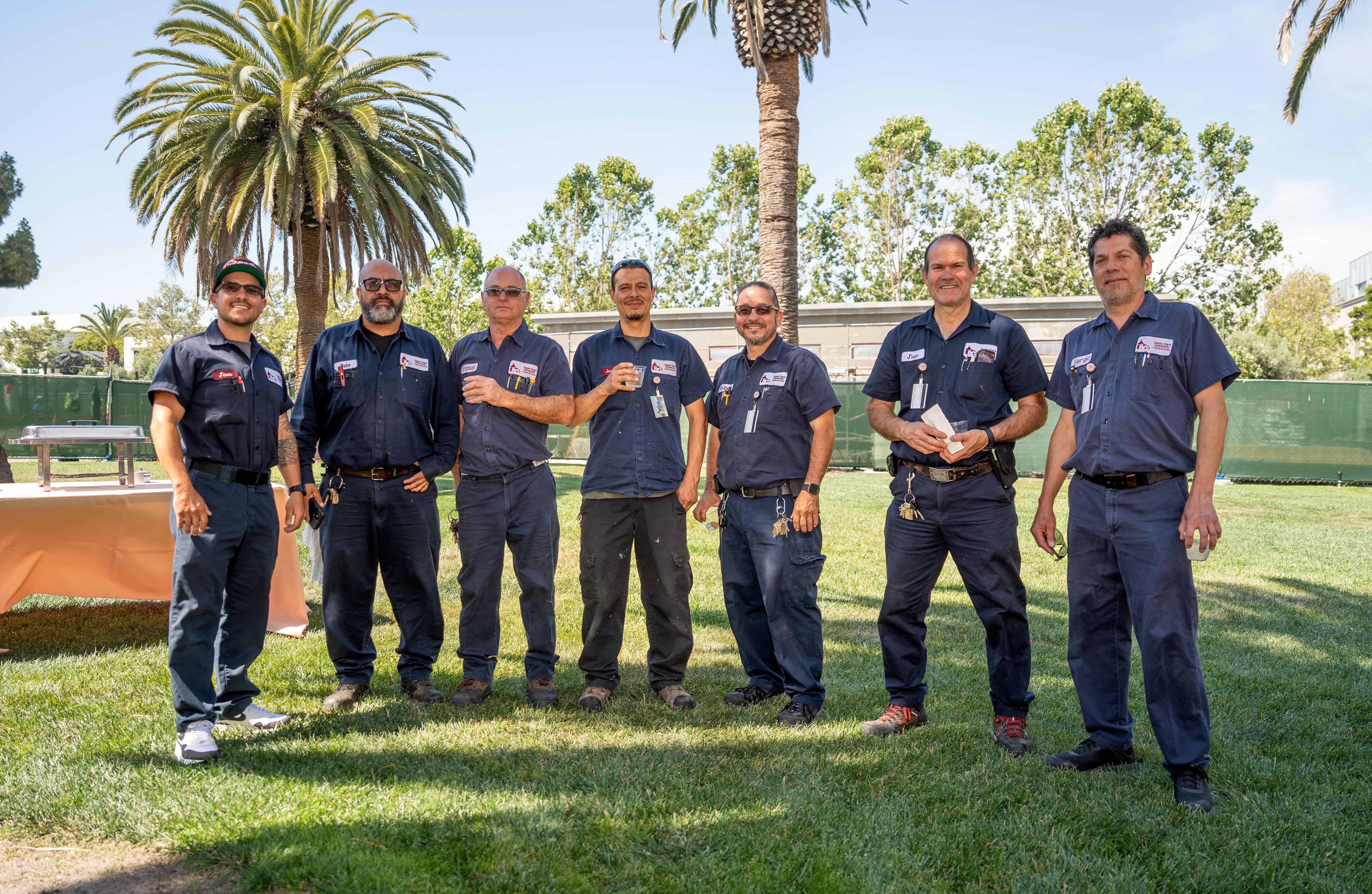 Facilities employees posing.