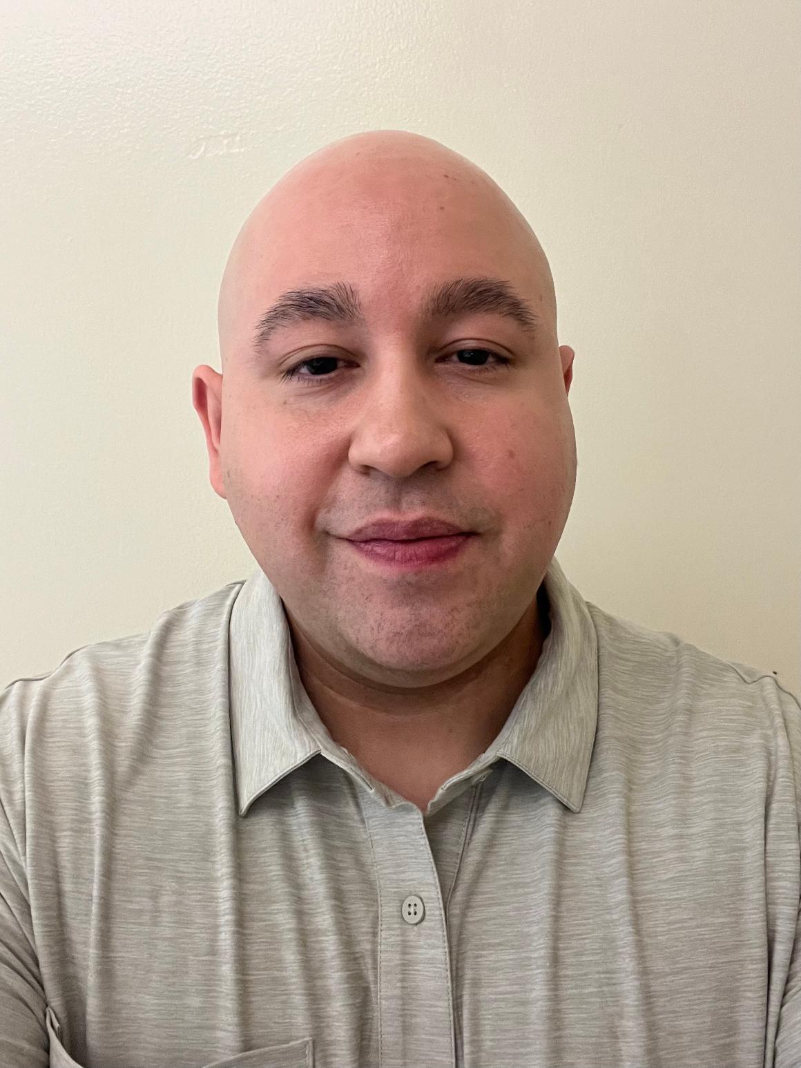 Man smiling in front of a camera