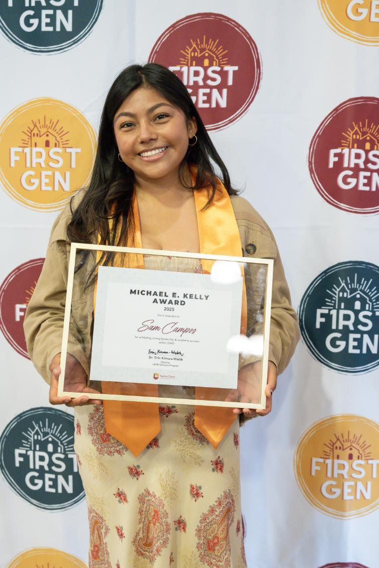 A woman holding a certificate in a gold frame