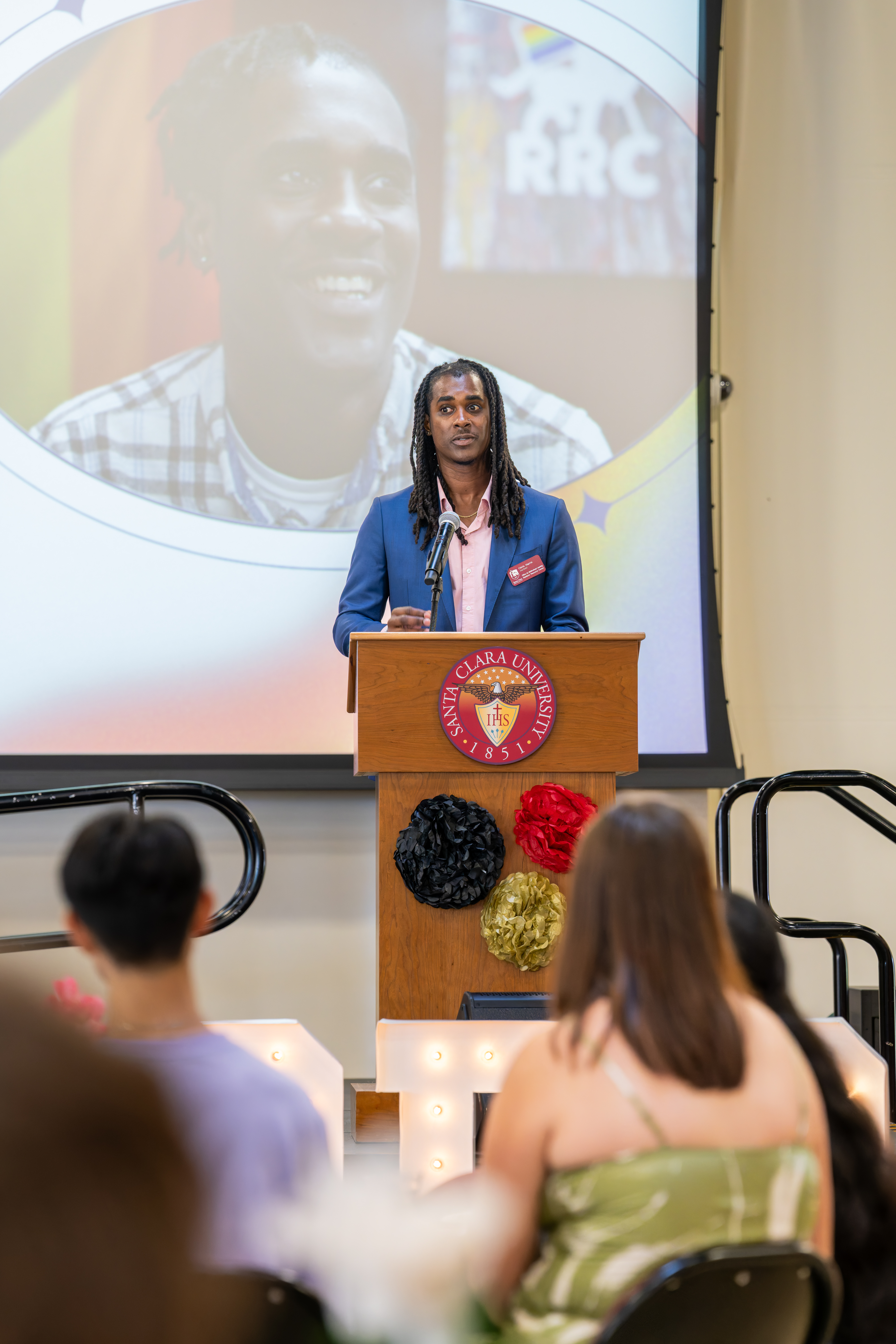 Chris standing at podium