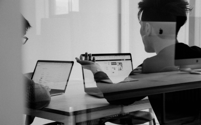 teacher and student sitting at table having a discussion 